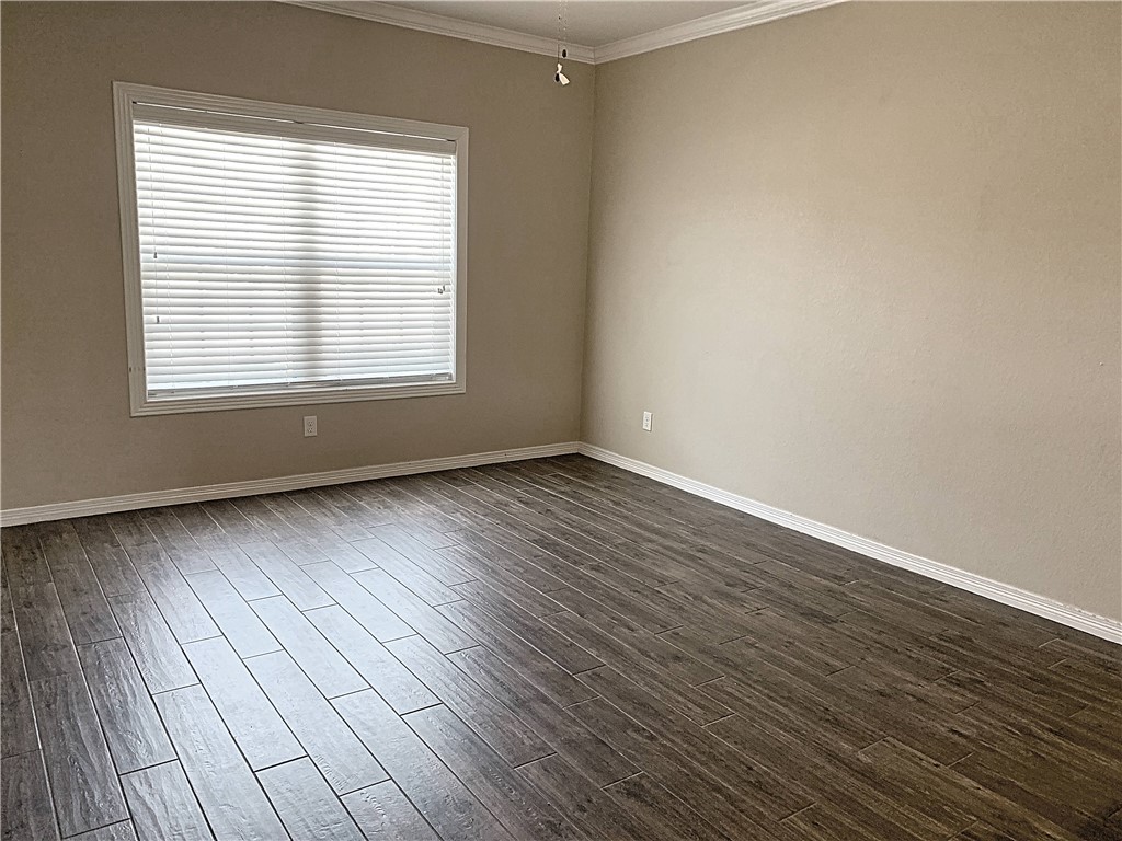 301 Southwest Parkway, Unit 351 College Station, TX 77840 - Photo 2 of 10 a view of an empty room with wooden floor and a window
