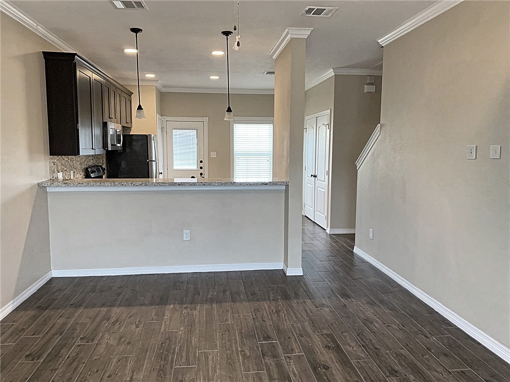 301 Southwest Parkway, Unit 351 College Station, TX 77840 - Photo 3 of 10 a view of kitchen with cabinets and wooden floor