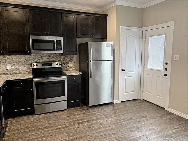 a view of kitchen with cabinets and wooden floor