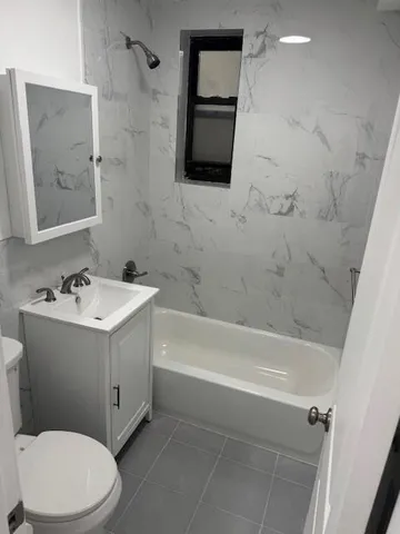 a bathroom with a sink mirror vanity and toilet