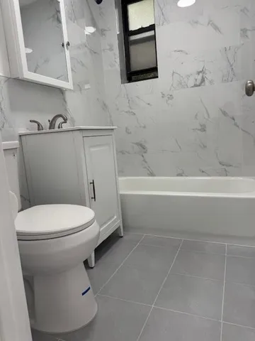 a bathroom with a toilet a sink and bathtub