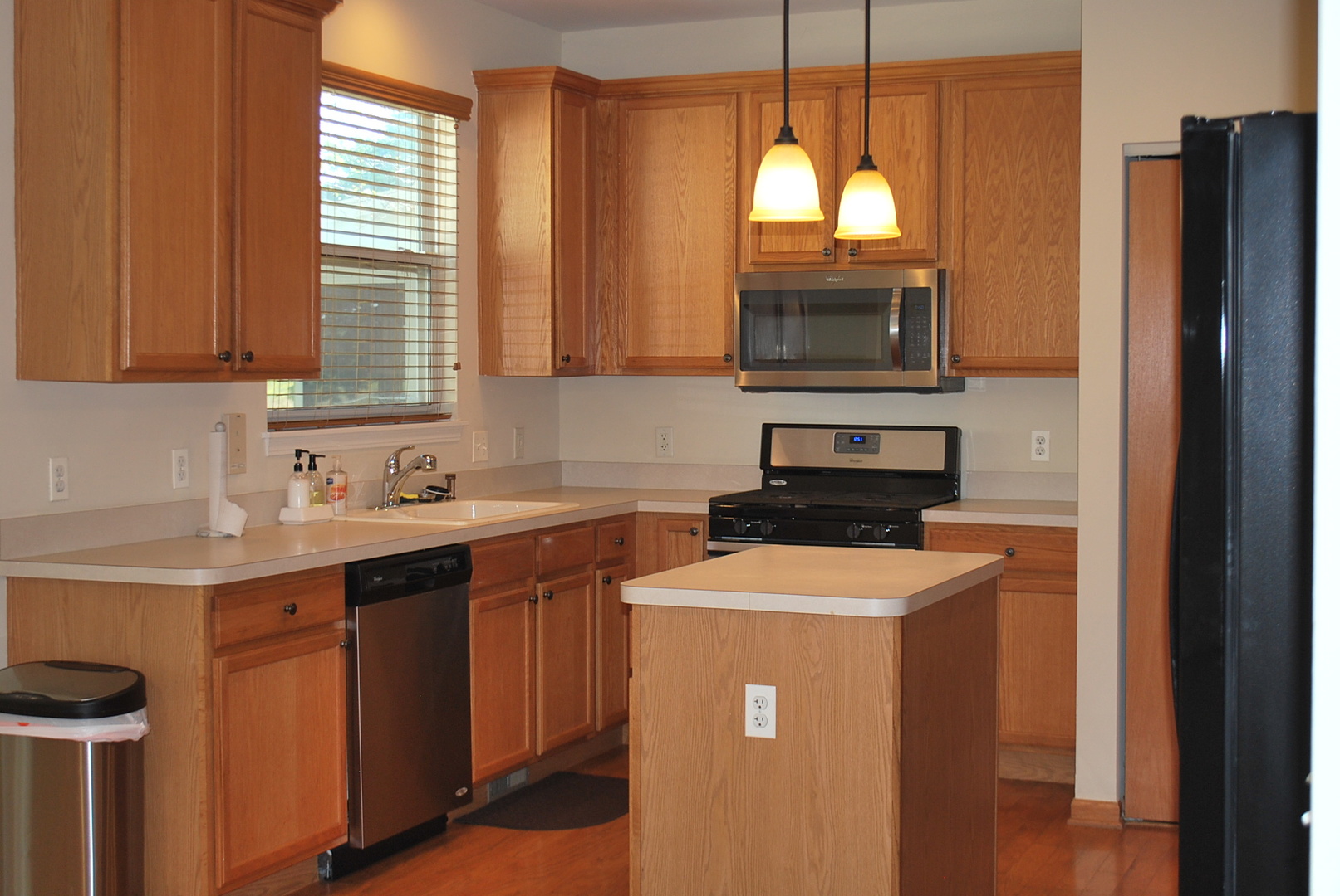 1528 Ludington Circle Romeoville, IL 60446 - Photo 3 of 22 a kitchen with stainless steel appliances granite countertop a stove a sink and a microwave