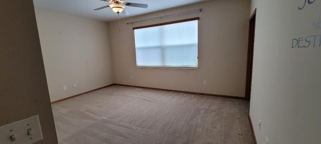 1528 Ludington Circle Romeoville, IL 60446 - Photo 9 of 22 an empty room with a window and a ceiling fan