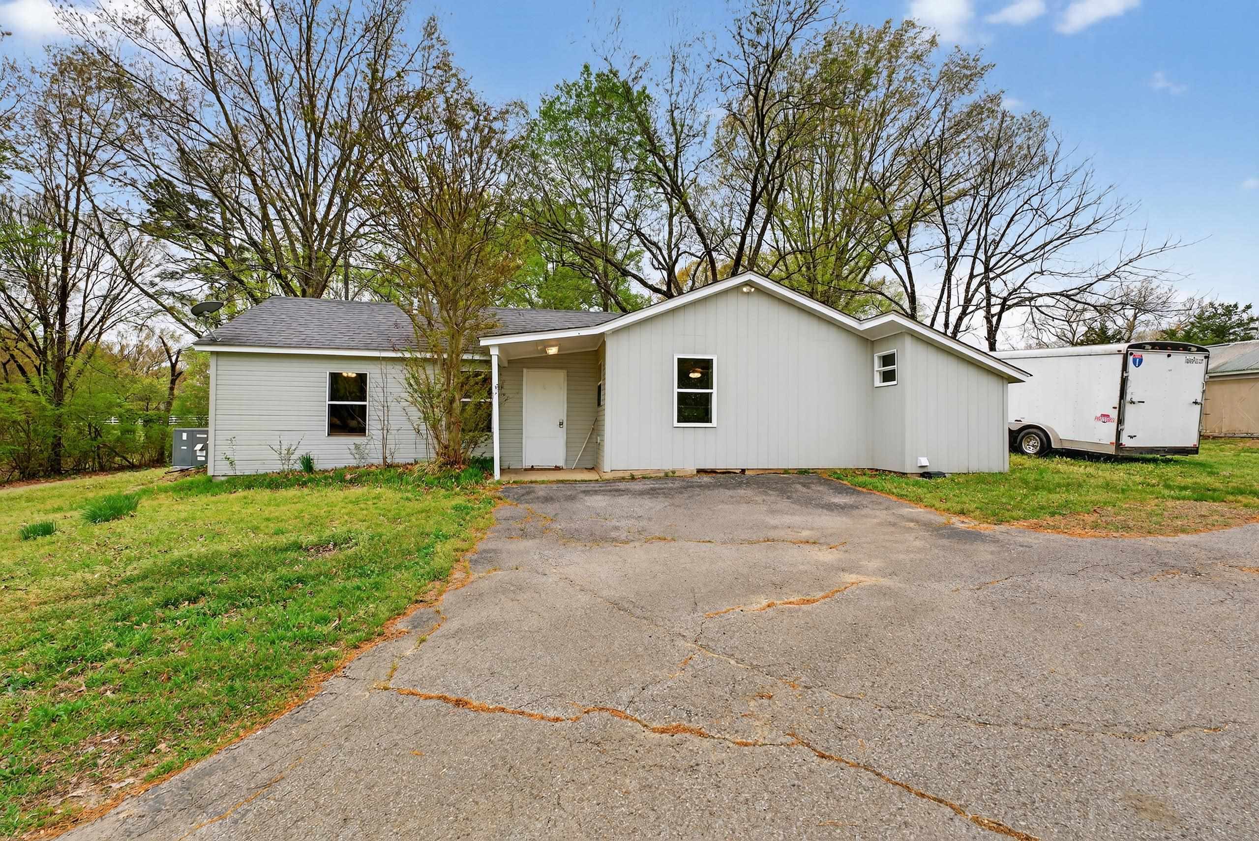 700 North Reid Hooker Road Eads, TN 38028 - Photo 16 of 20 View of front of home featuring a front yard, asphalt driveway, and roof with shingles