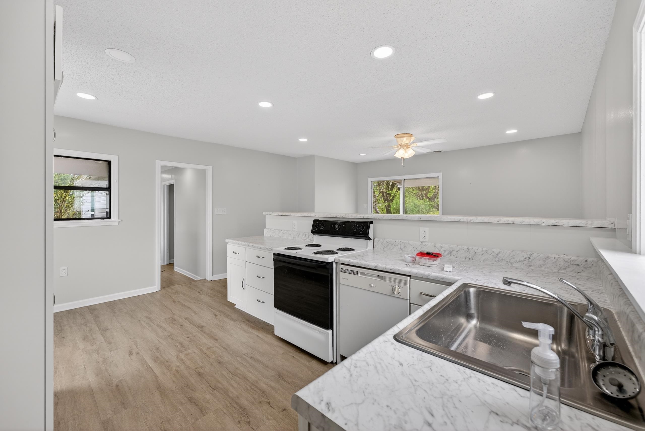 700 North Reid Hooker Road Eads, TN 38028 - Photo 17 of 20 Kitchen with light countertops, white appliances, light wood finished floors, recessed lighting, and ceiling fan
