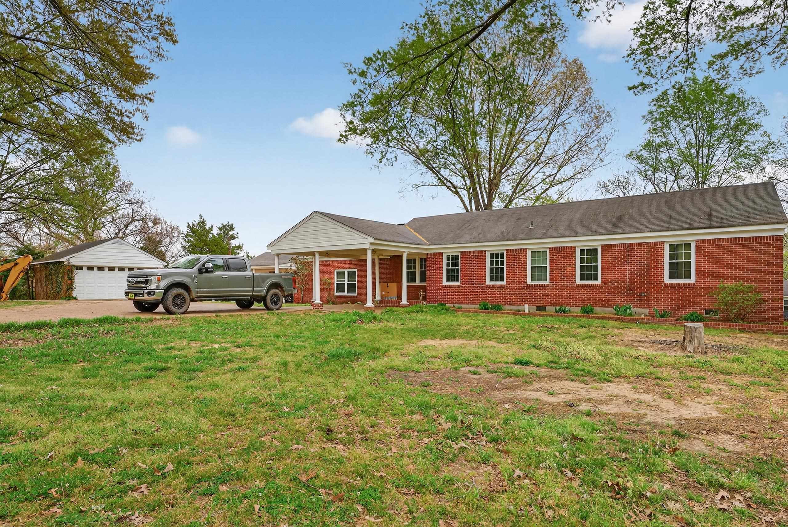 700 North Reid Hooker Road Eads, TN 38028 - Photo 9 of 20 Ranch-style home with brick siding, a front yard, and a detached garage