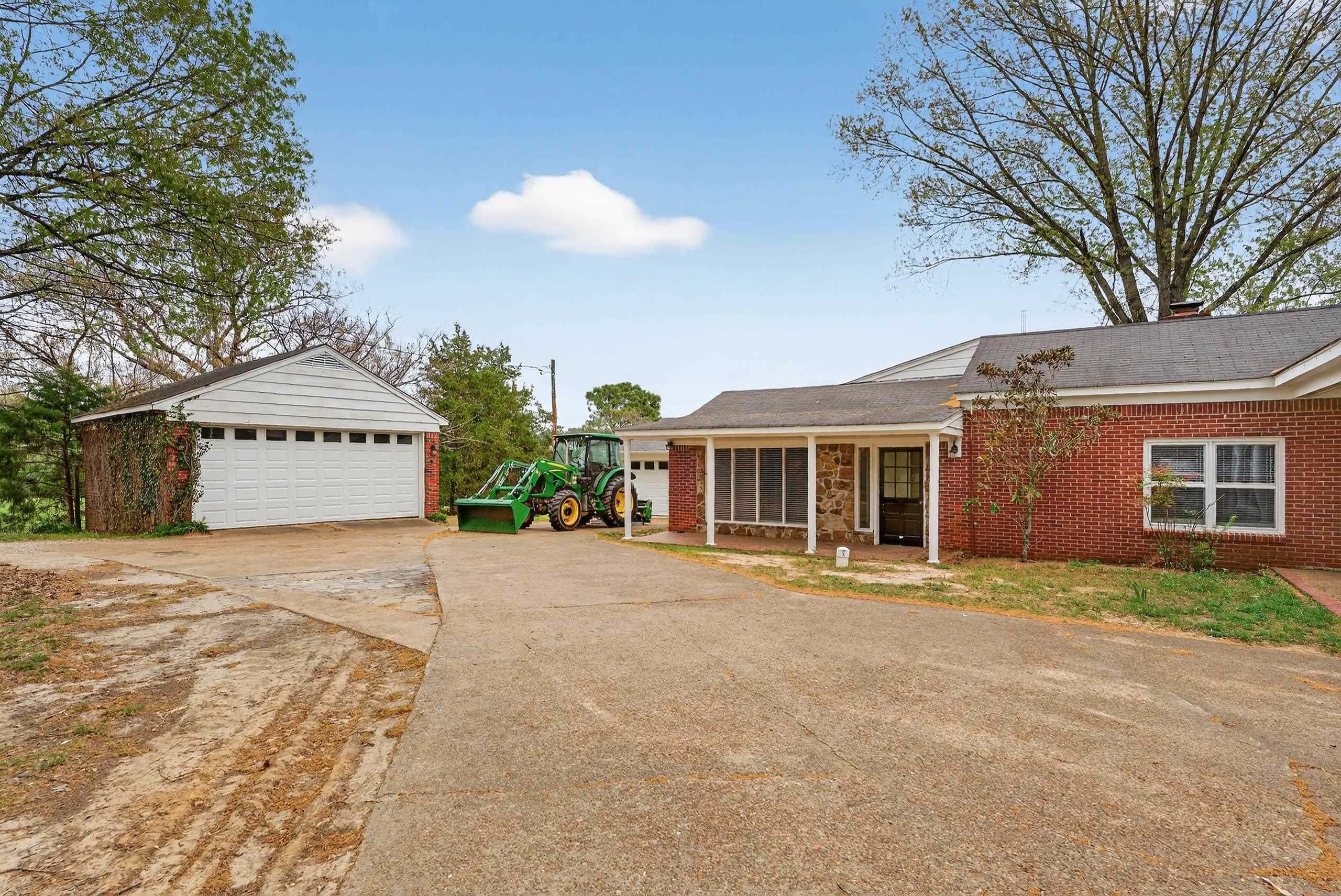 700 North Reid Hooker Road Eads, TN 38028 - Photo 10 of 20 Ranch-style house with a garage, an outdoor structure, brick siding, and a shingled roof