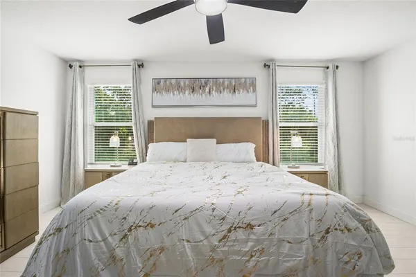 a large bed sitting in a bedroom next to a window