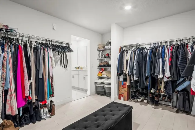 a view of walk in closet with clothes