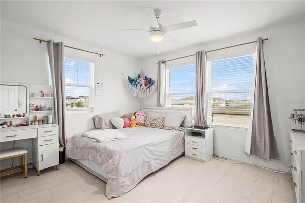 a bedroom with a bed dresser and a window