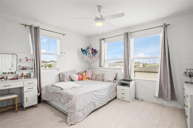 a bedroom with a bed dresser and a window