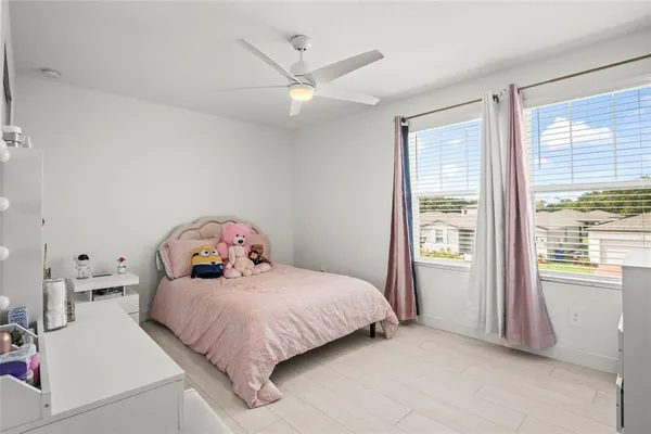 a bedroom with a bed and a large window with the outer view