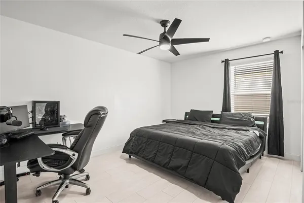 a bed sitting in a bedroom next to a window