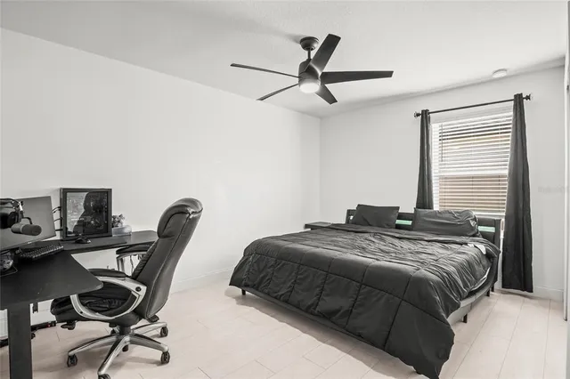 a bed sitting in a bedroom next to a window