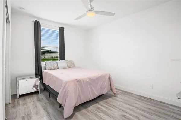 a bedroom with a bed and a window