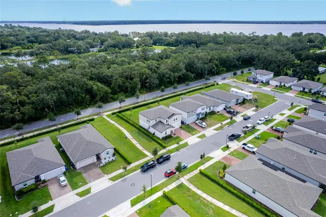 an aerial view of a tennis ground and a yard