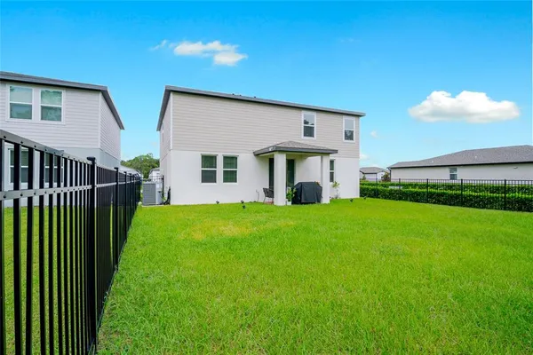 a view of a house with backyard and porch