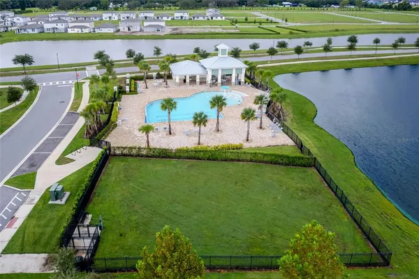 a view of a swimming pool with a yard and plants