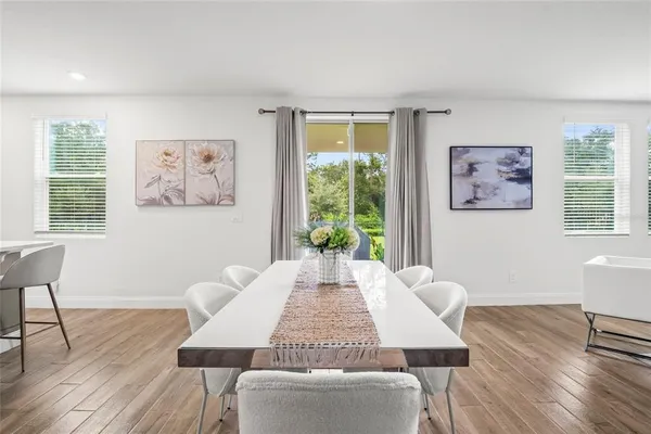 a view of a dining room with furniture window and wooden floor