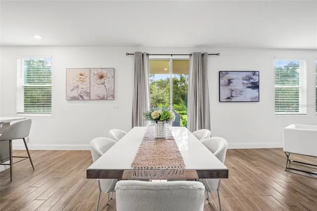a view of a dining room with furniture window and wooden floor