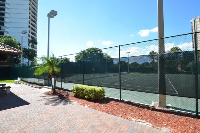 a view of a patio with chairs and plants