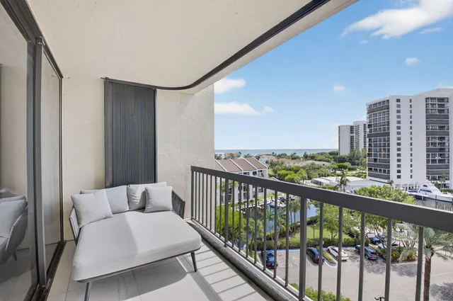a view of a chair and tables in the patio