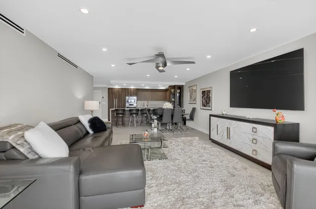 a large white kitchen with a large window