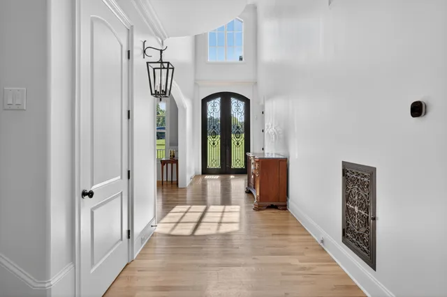 a living room with furniture kitchen view and a wooden floor