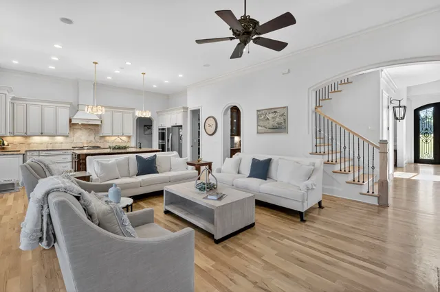 a en suite bathroom with a granite countertop double vanity sink a mirror and a shower