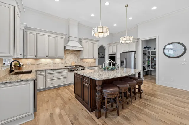 a kitchen with a sink stove and cabinets