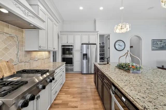 a view of an entryway with wooden floor and a livingroom view