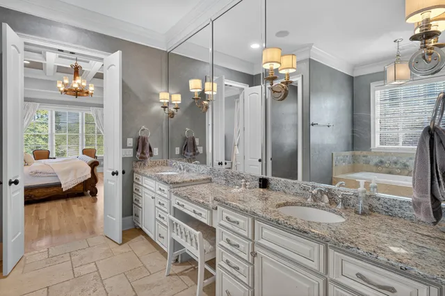 a spacious bedroom with a bed flat screen tv and a large window