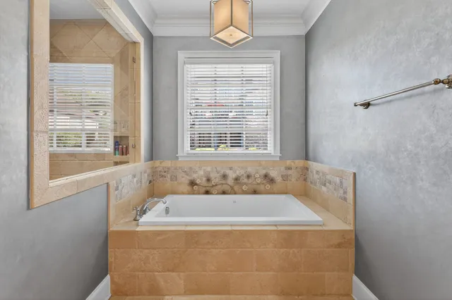 a spacious bedroom with a bed and a flat screen tv