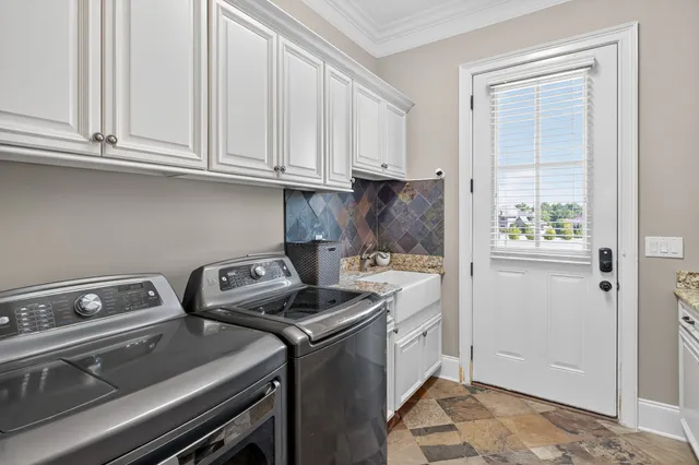 a front view of a house with yard and green space