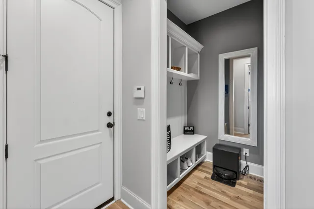 a view of a house with a yard and potted plants