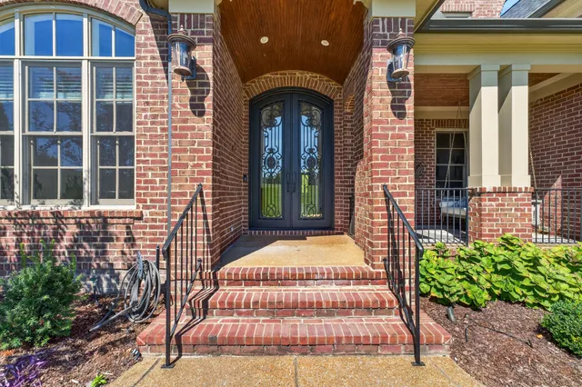 a view of a hallway with wooden floor and a living room