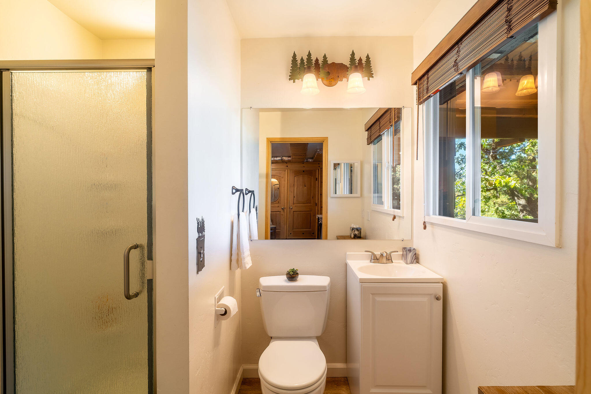 24675 Rocky Point Road Idyllwild, CA 92549 - Photo 37 of 64 a bathroom with a toilet sink and mirror