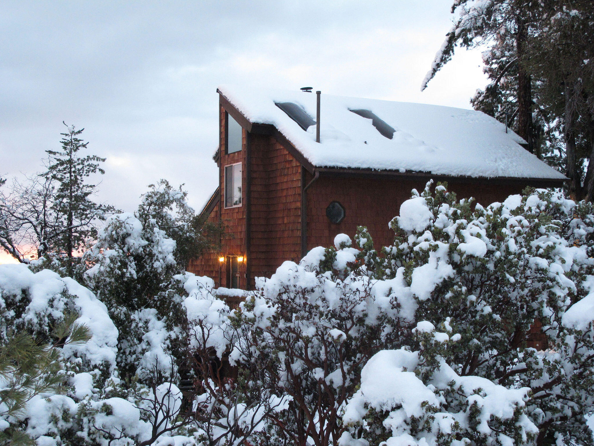 24675 Rocky Point Road Idyllwild, CA 92549 - Photo 64 of 64 a front view of a house with a yard and flowers