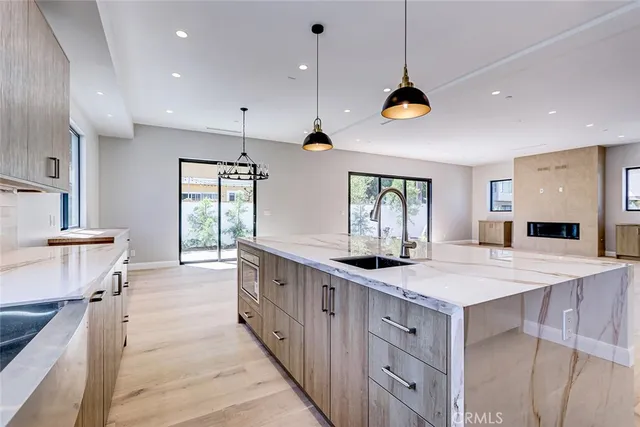 a kitchen with kitchen island granite countertop lots of counter top space and stainless steel appliances