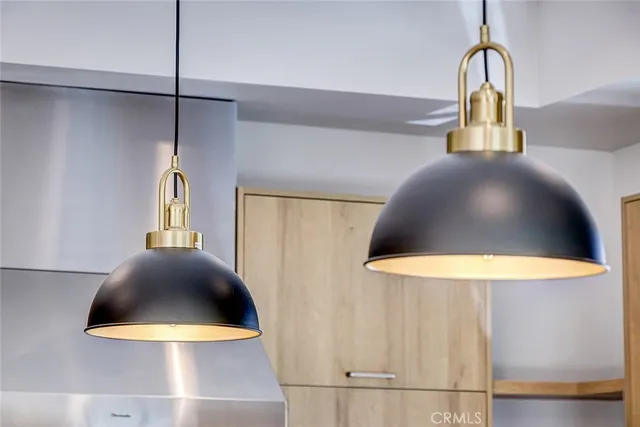 a view of a chandelier fan and kitchen view