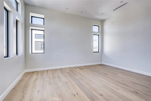 an empty room with windows and closet