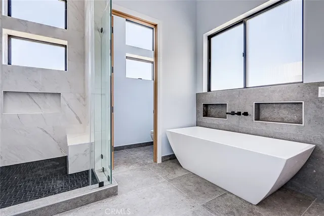 a spacious bathroom with a tub and shower