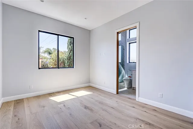an empty room with wooden floor and closet