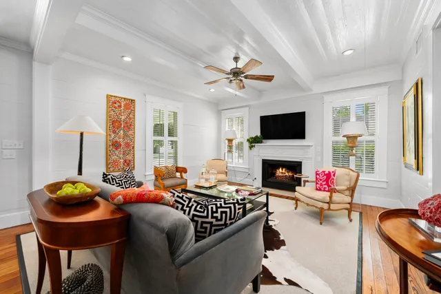 a living room with furniture a fireplace and a flat screen tv