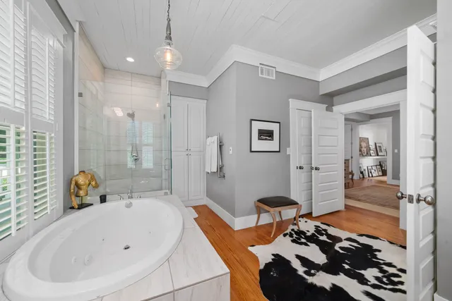 a bathroom with a tub a sink and a shower