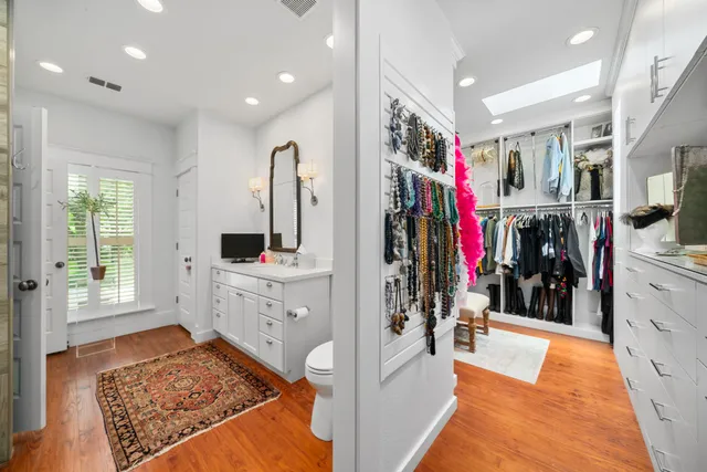 a view of walk in closet with clothes and shoes