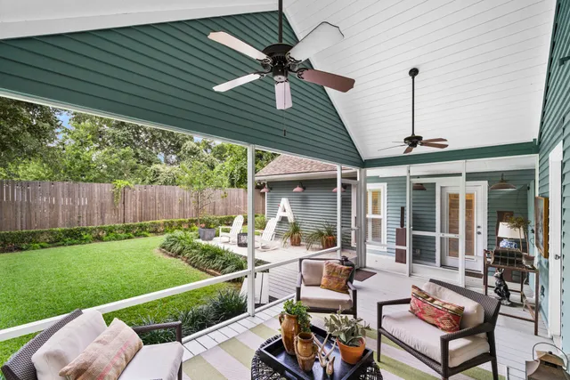 a living room with furniture flat screen tv and a large window