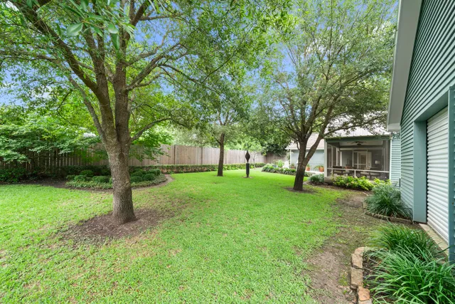 a view of an house with backyard space and garden