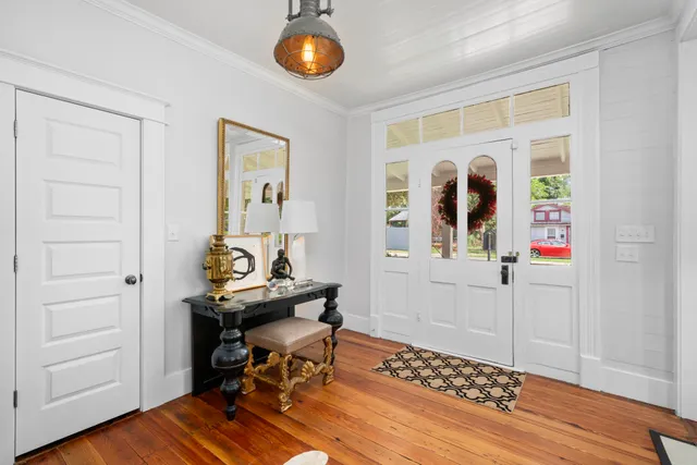 a view of a workspace with furniture and wooden floor