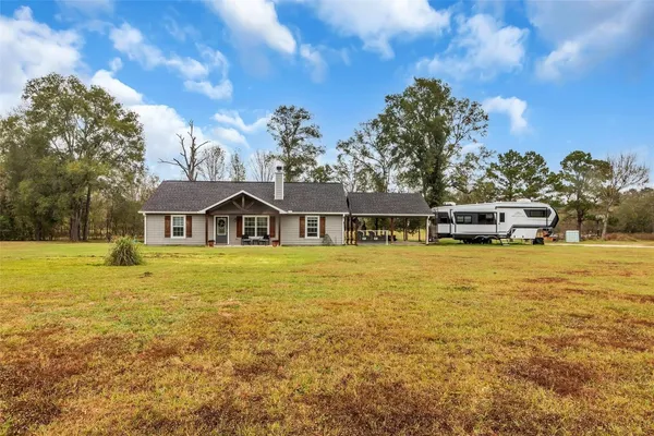 a front view of a house with a big yard